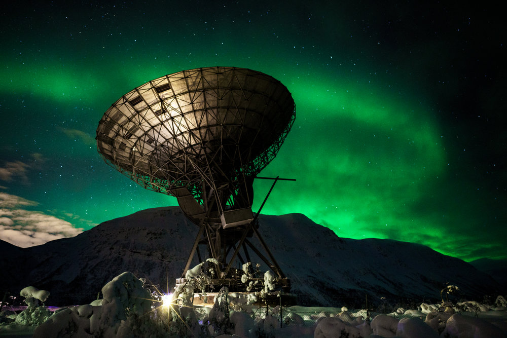This is one of my favorite photographs taken at the EISCAT research station in Northern Norway. On this particular night the Northern Lights were not very strong, but present enough to capture some bands for a rather nice composition. Using a Zeiss 21mm f/2.8 lens on a Sony A7RII allowed me to capture all of the sky along with the dish and snow in the foreground. With the combination of a wide angle lens and fast aperture,&nbsp;I was able to gather enough light (to make the weaker aurora brighter)&nbsp;and keep the stars sharp with a shutter speed of only a few seconds.