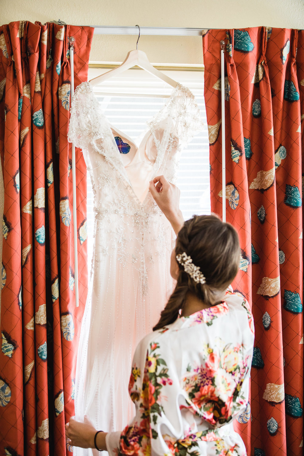 Wedding photograph of a bride looking at her dress at the Hollander Hotel in St. Petersburg, Florida