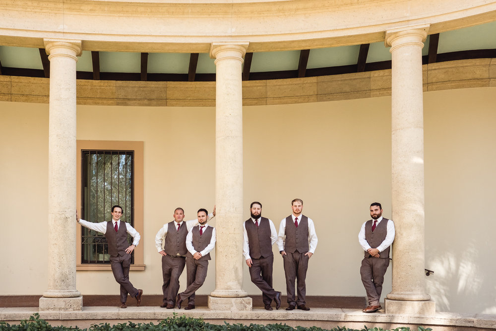 Groom and groomsmen pose by columns outside the Museum of Fine Arts in downtown St. Petersburg, Florida 