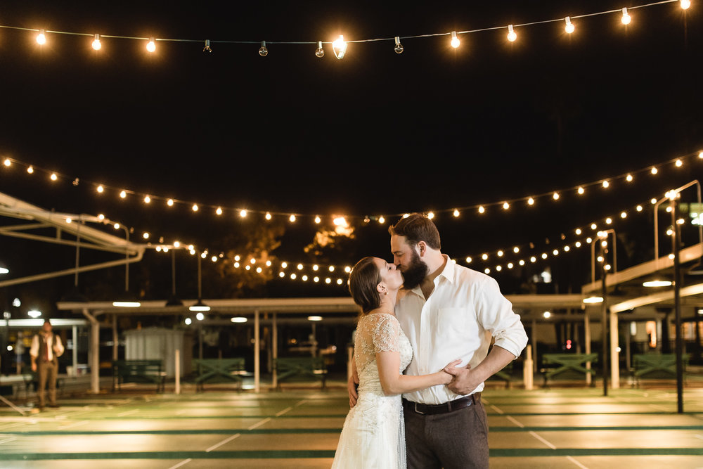 Dramatic nighttime wedding photograph of Bride and Groom at St. Pete Shuffle Wedding Portrait at the Shuffleboard Club in St. Petersburg, Florida 
