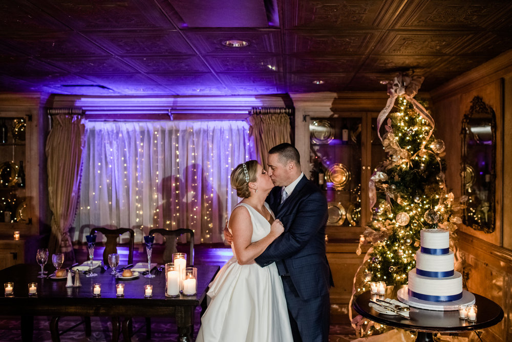 Bride and groom inside during their winter wedding at the grain house in basking ridge new jersey with blue and orange Christmas themed lights