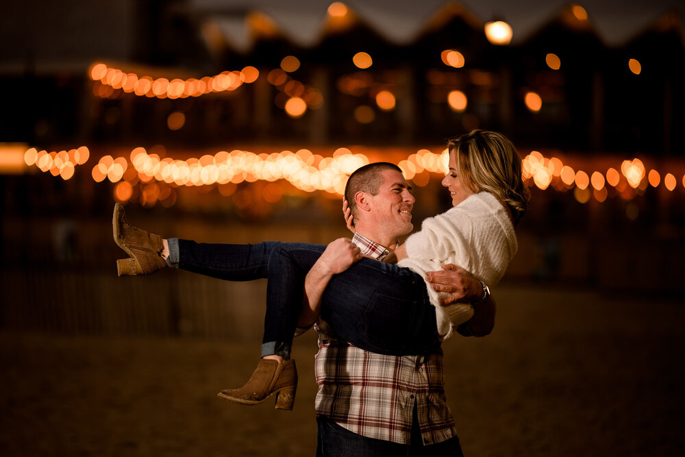 New Jersey Wedding Photographer, NJ Engagement Photographer, New Jersey Engagement Photographer, NJ Wedding Photographer, Asbury Park Engagement Photographer, Engagement Session in NJ, New Jersey Engagement Sessions, Engagement Session in New Jersey, Engagement Photography, Engagement Inspiration, Wedding Planning, Engagement Session Ideas, Unique Engagement Photos, Engagement Session Photo Ideas, Fun Engagement Photos, Night Time Photo with boardwalk lights, Partner being picked up