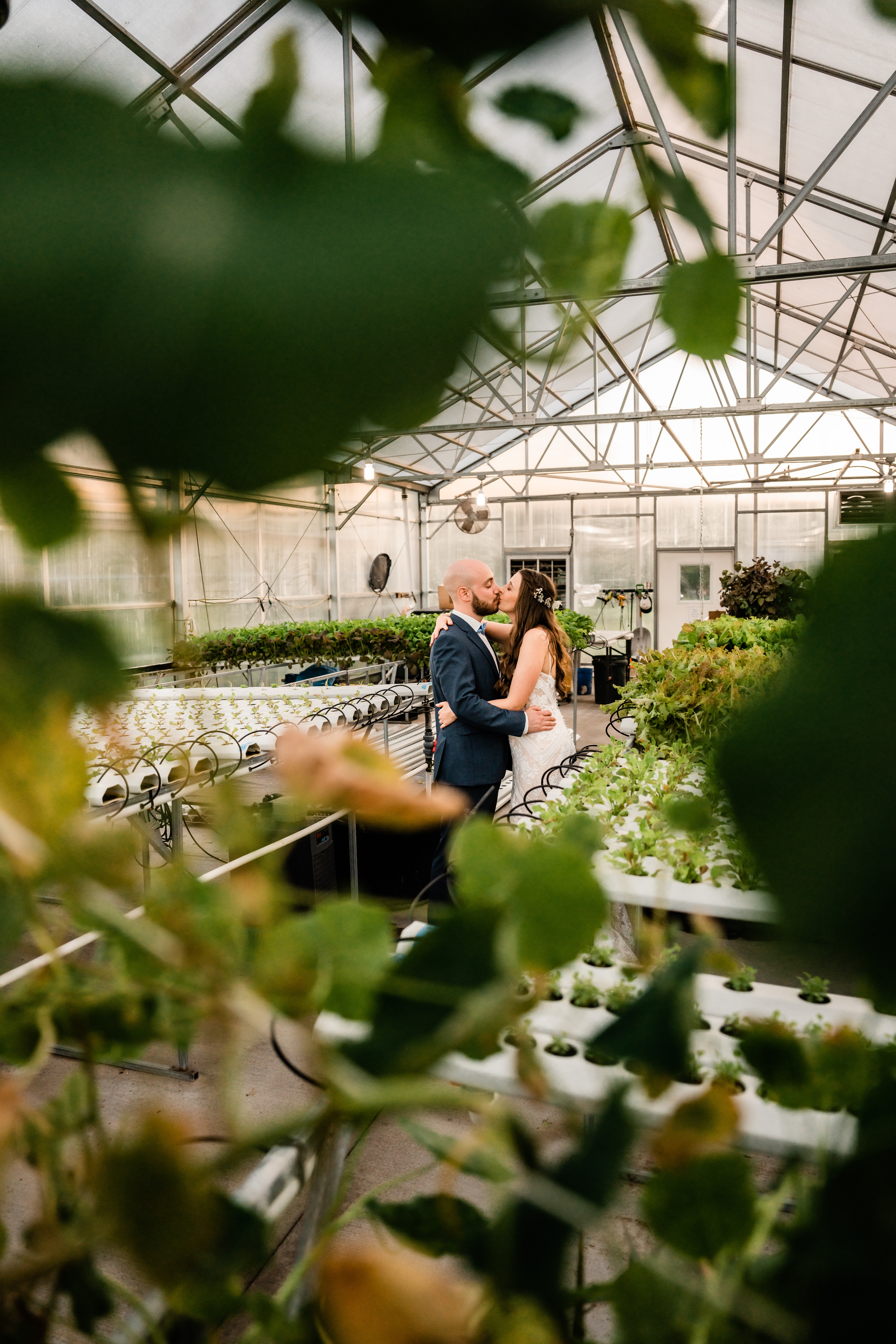The Barn at Perona Farms, Perona Farms Wedding, New Jersey Wedding Photographer, Sussex County Wedding Photographer, NJ Wedding Photographer, Sussex County NJ Photographer, New Jersey Wedding Venues, Sussex County Wedding Venue, Wedding Inspiration, Wedding Planning, Wedding Ideas, Unique Wedding Photos, Wedding Photo Ideas, Boho Wedding, Farm Wedding, Bride and groom kissing in the Perona Farms greenhouse in Andover NJ