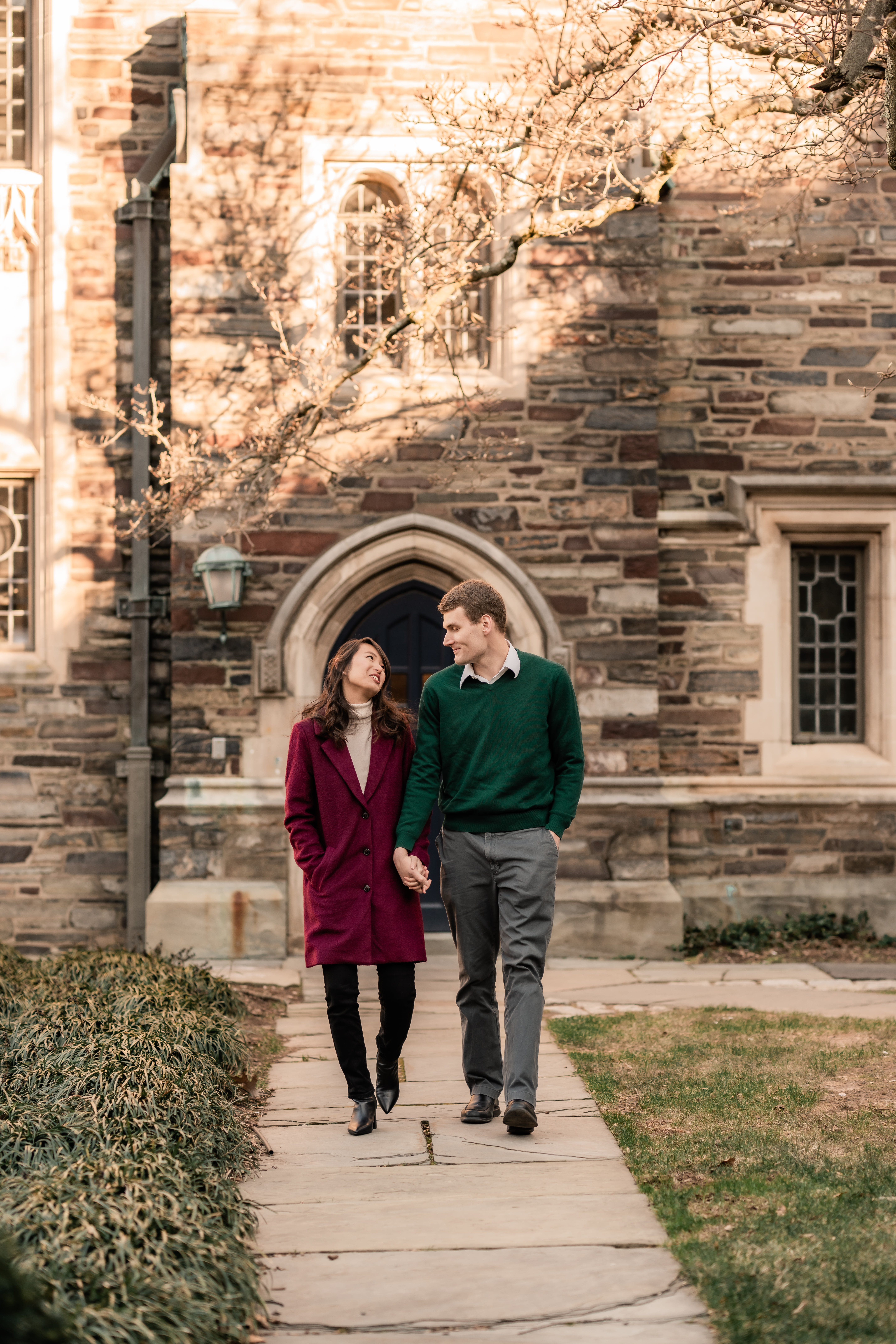 New Jersey Wedding Photographer, New Jersey Engagement Session, Princeton University Engagement Session, Princeton University Wedding Photographer, New Jersey Wedding Venues, NJ Wedding Photographer, Unique Wedding Ideas, Princeton University, Modern Wedding Couple, Wedding Inspiration, Wedding Planning, Princeton NJ, couple walking hand and hand away from a university building while smiling and looking at each other 