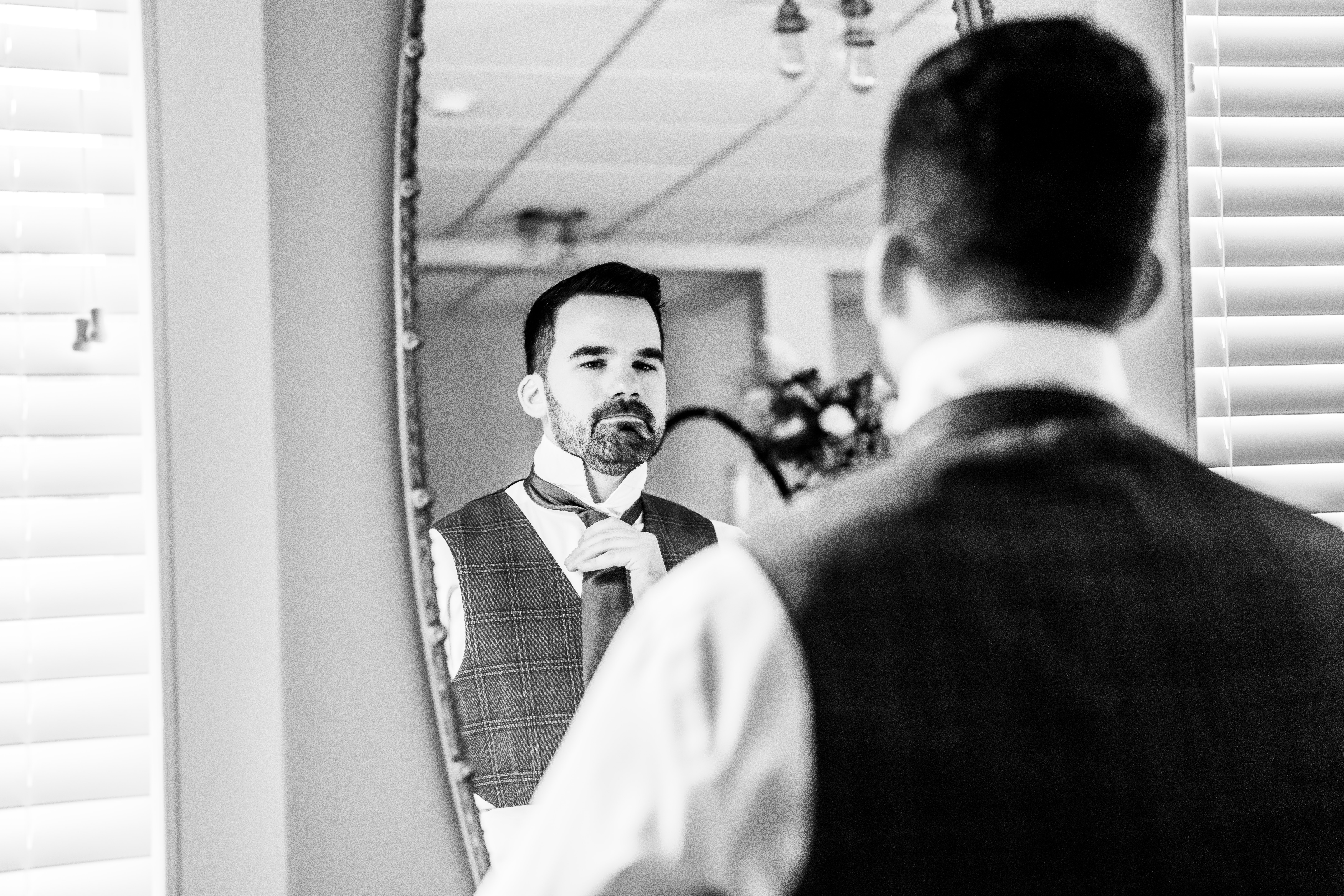Running Deer Golf Club Wedding Venue, Running Deer Golf Club Wedding Photographer, NJ Weddings, New Jersey Wedding Photographer, Pittsgrove Wedding Photographer, NJ Wedding Photographer, Salem County NJ  Photographer, New Jersey Wedding Venues, Salem County Wedding Photography, Wedding Inspiration, Wedding Planning, Unique Wedding Photos, Wedding Photo Ideas, black and white candid photograph of groom looking into the mirror while fixing his tie 