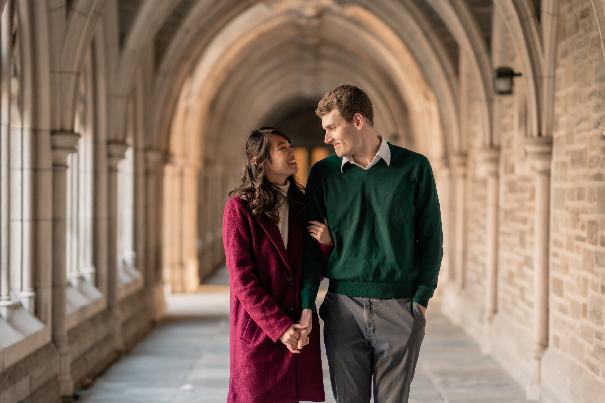 Princeton University Engagement, Princeton University Engagement Photographer, NJ Engagement Photographer, New Jersey Photographer, couple walking through the halls of Princeton University holding hands and smiling while looking at each other 