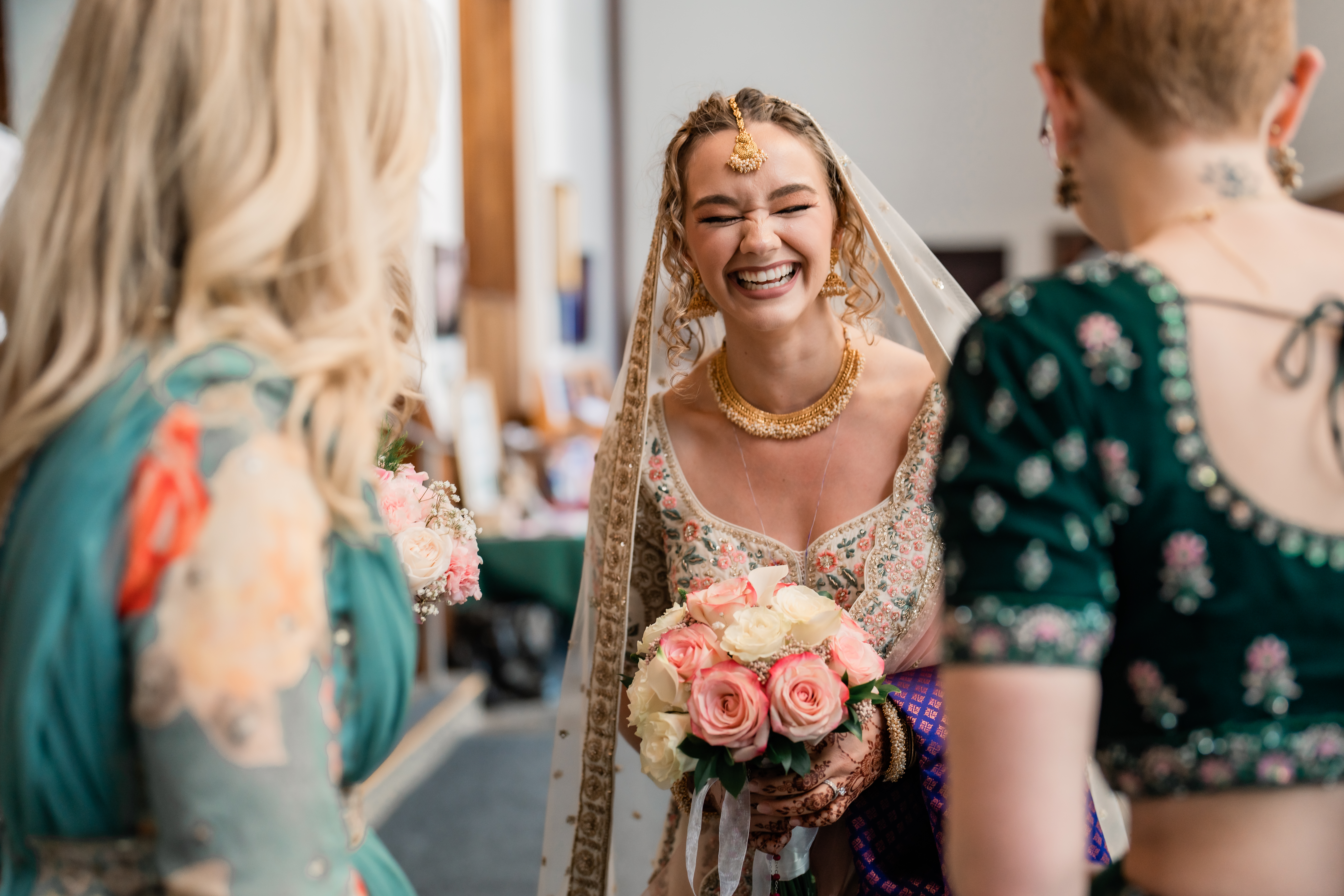 New Jersey Wedding Photographer, NJ Wedding Venue, New Jersey Weddings, NJ Wedding Photographer, Jersey Weddings, NJ Wedding Photographer, NJ Summer Wedding, Summer Wedding, Bride is laughing and smiling at her sister as she is wearing a traditional Indian Saree.
