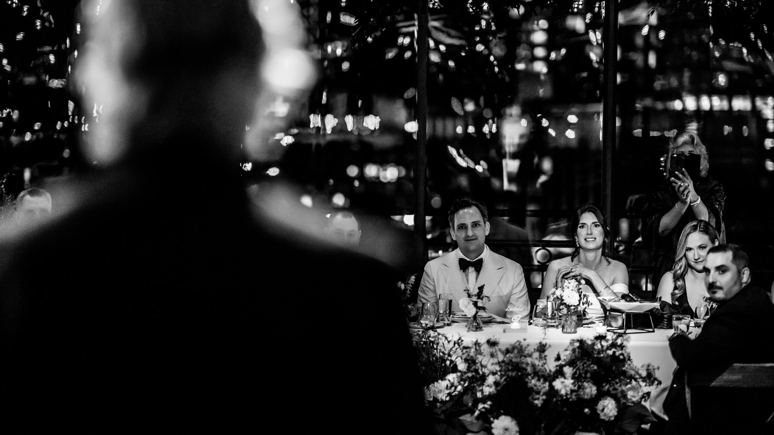 Box House Hotel Wedding, Brooklyn Wedding Photographer, NYC Wedding Photographer, NJ Wedding Photographer, Brooklyn Chic Wedding, Brooklyn Wedding Venue, NYC Wedding Venue, NYC Wedding, Disco Ball Wedding, Wedding Photo Inspiration, Wedding Photo Ideas, Cinematic Wedding Photography, Documentary Wedding Photography, creative over the shoulder black and white candid of bride and groom reacting to father of the bride speech.