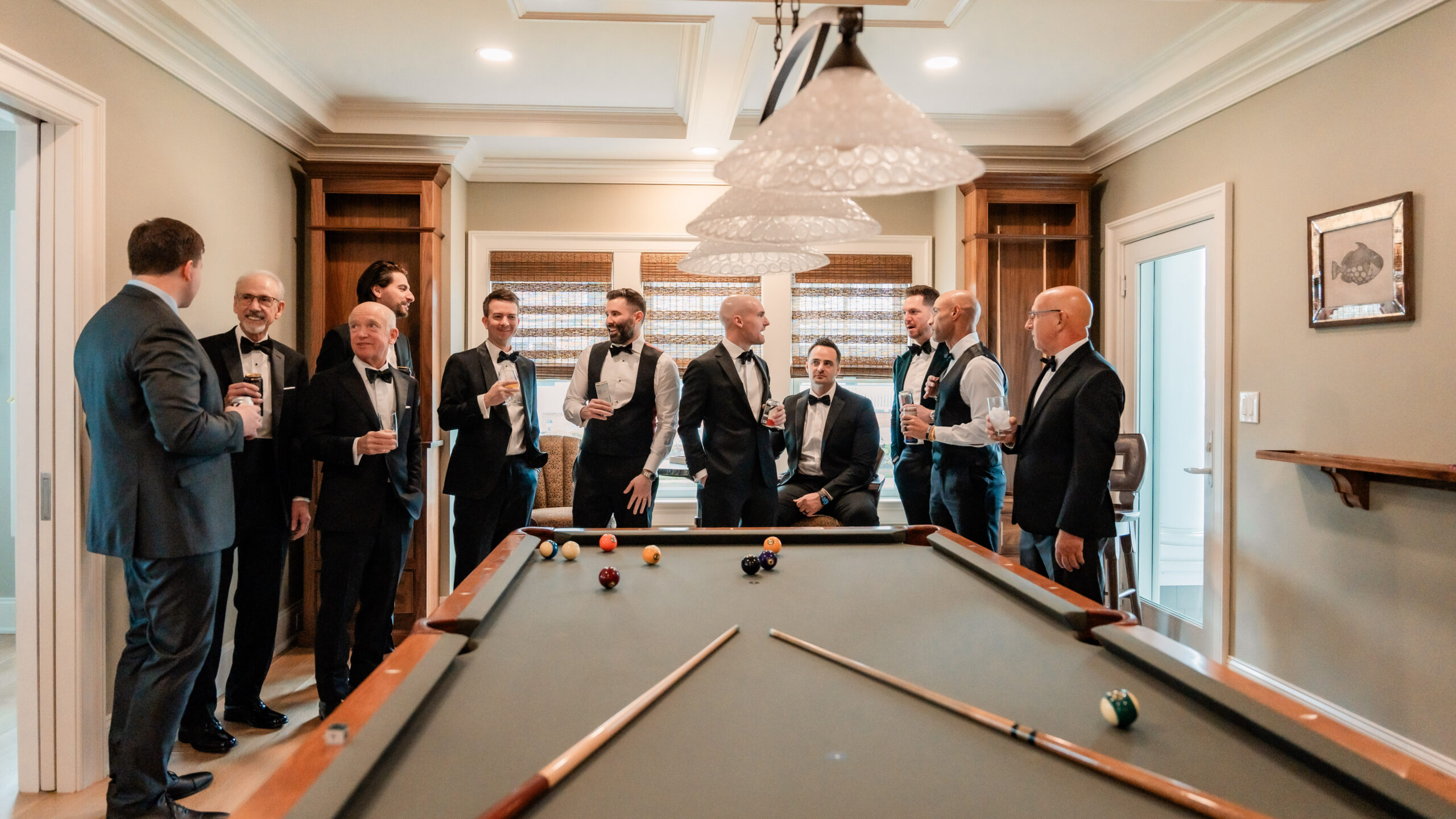 Park Loft wedding photography showing the groom and groomsmen relaxing around a pool table before the ceremony in Oceanport, NJ.