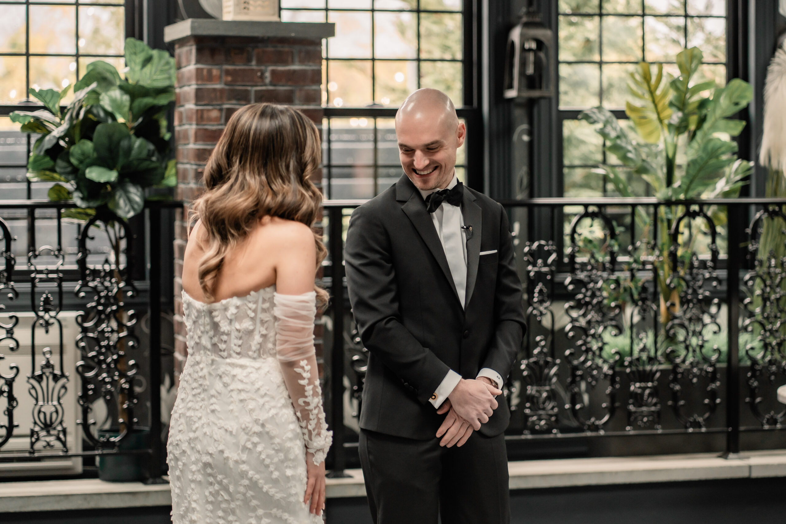 Emotional first look at a Park Loft wedding in New Jersey, with the groom smiling as he sees the bride for the first time.