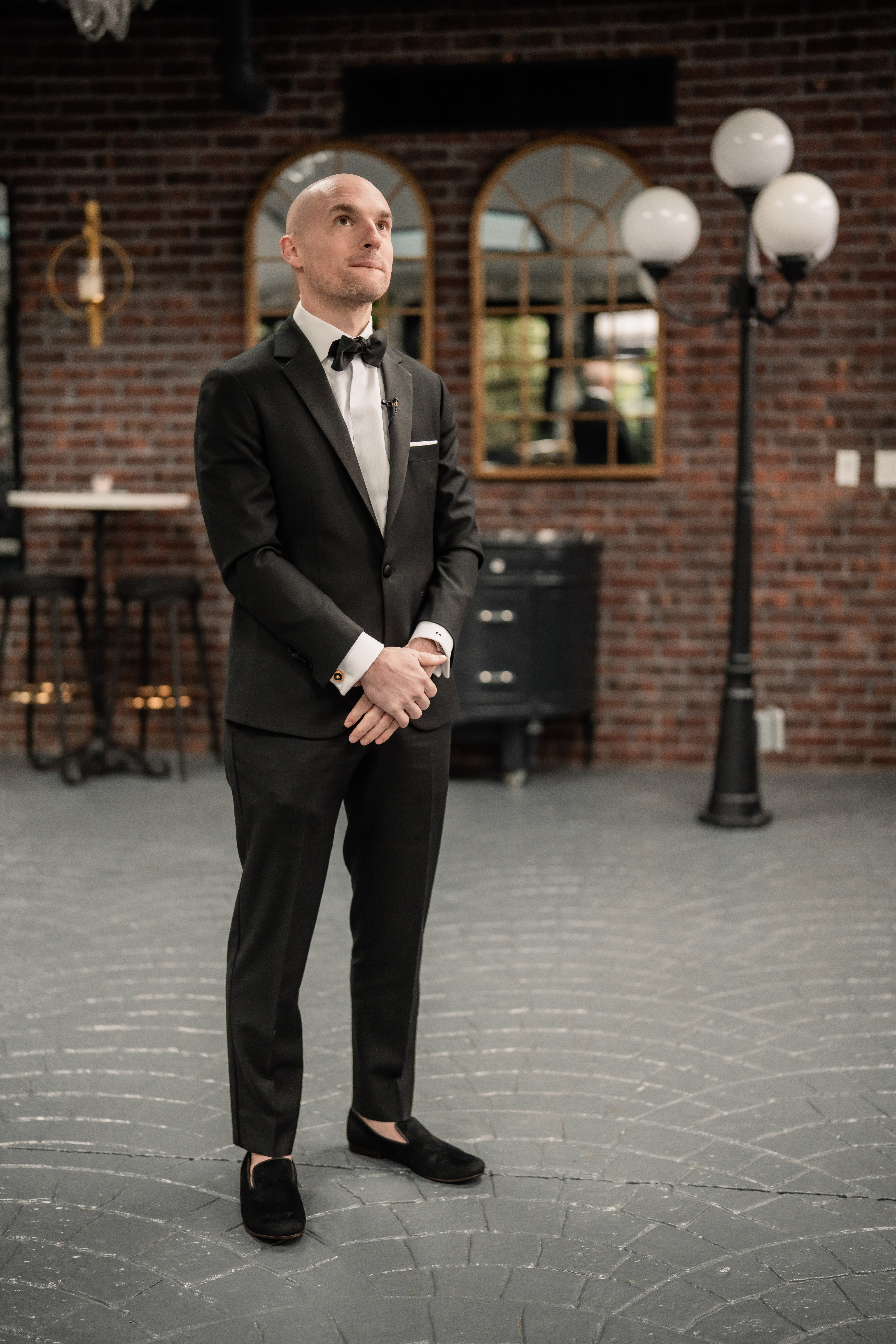 Park Loft wedding photographer capturing the groom waiting for his first look inside the venue’s brick-and-iron interior in Oceanport, NJ.