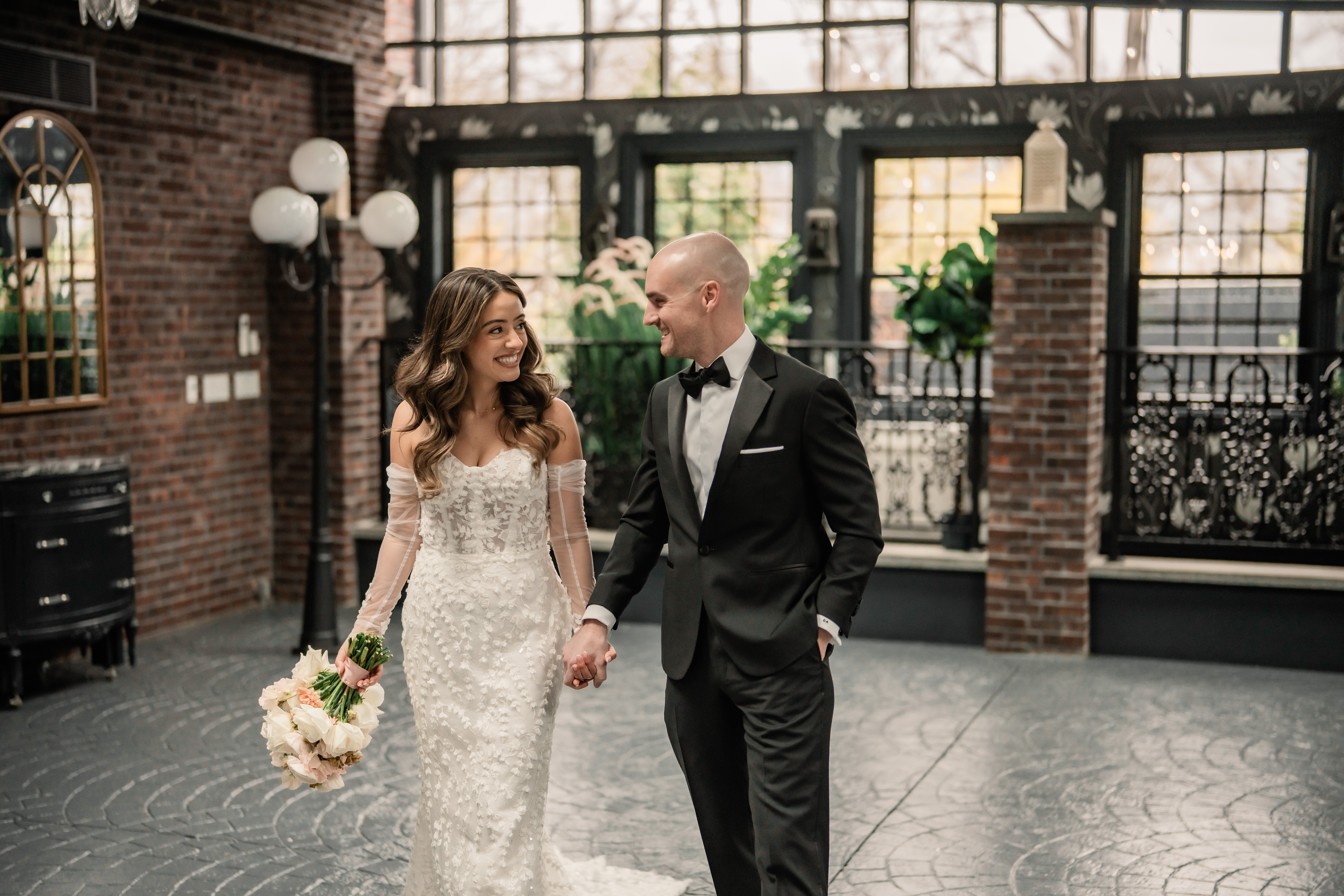 Park Loft wedding portraits in Oceanport, NJ, with the bride and groom walking hand in hand through the venue after their emotional first look.