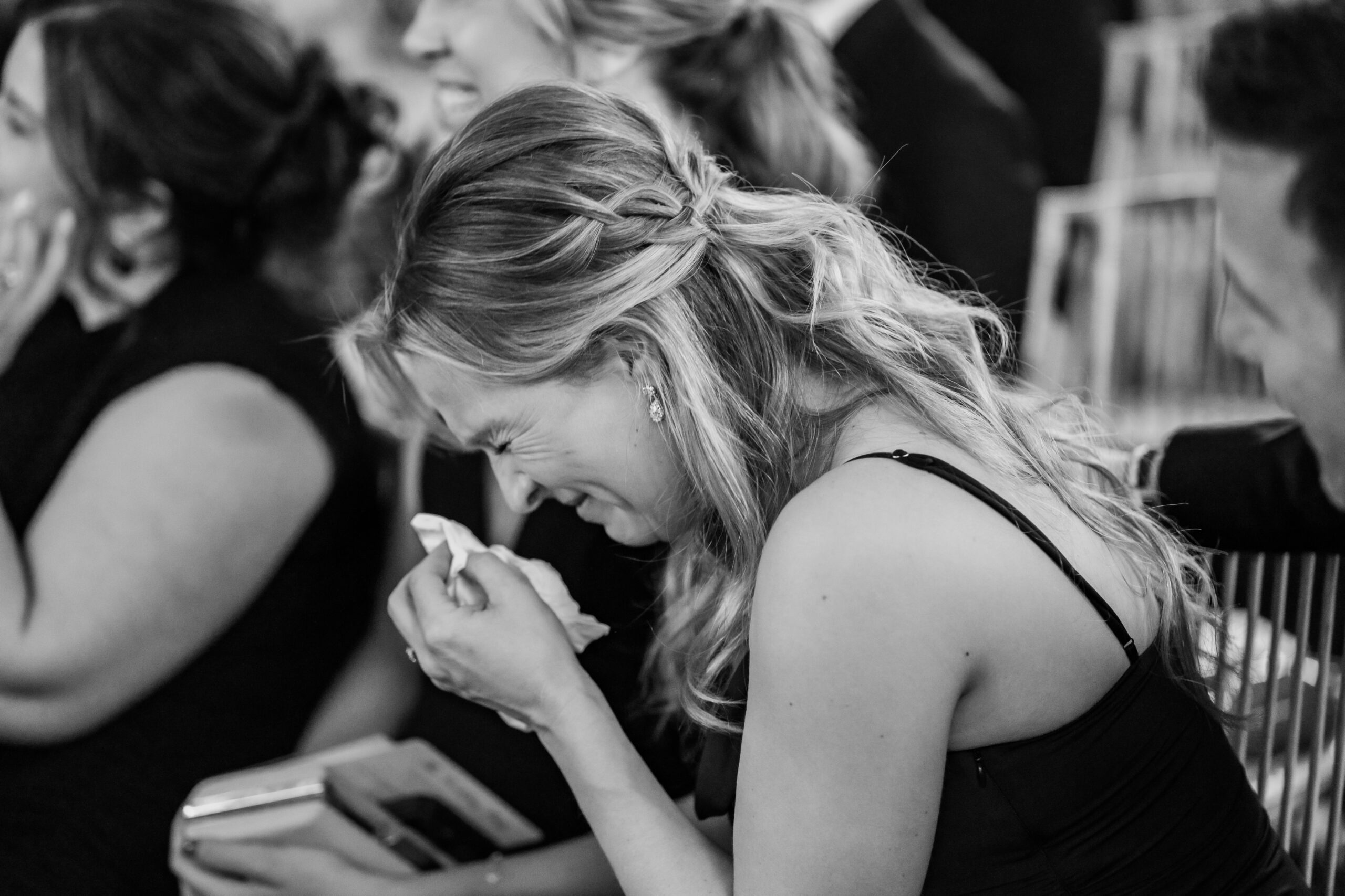 Emotional black-and-white New Jersey wedding photography capturing a guest wiping away tears during a Park Loft ceremony.