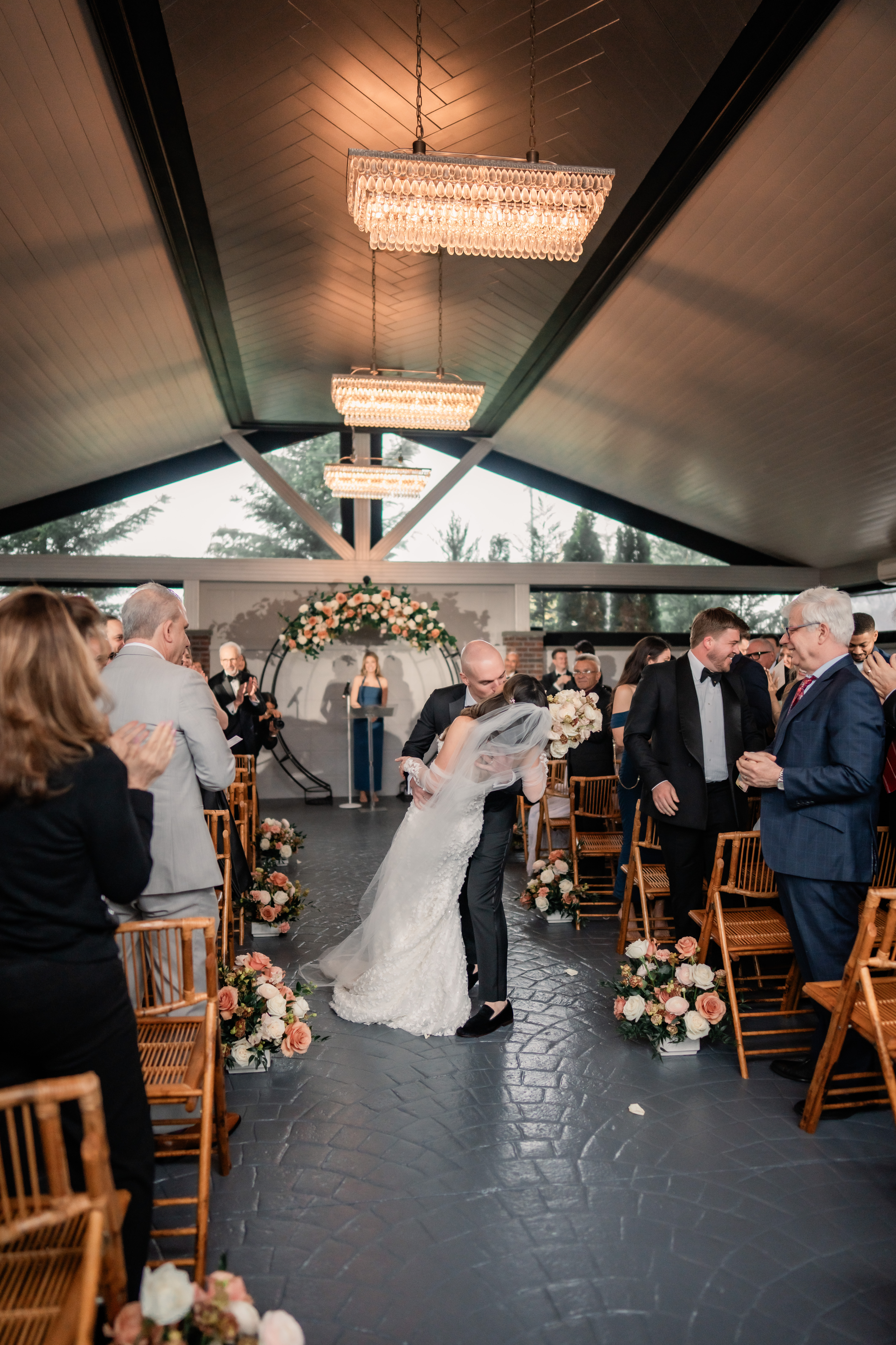 Joyful Park Loft wedding photography showing the newlyweds celebrating with a dramatic dip as they walk back up the aisle after their ceremony.