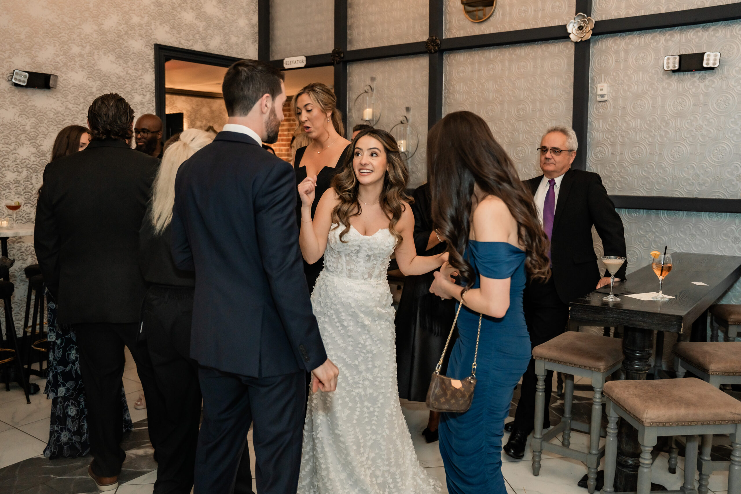 New Jersey wedding photography at Park Loft showing the bride laughing and talking with guests during a relaxed cocktail hour.