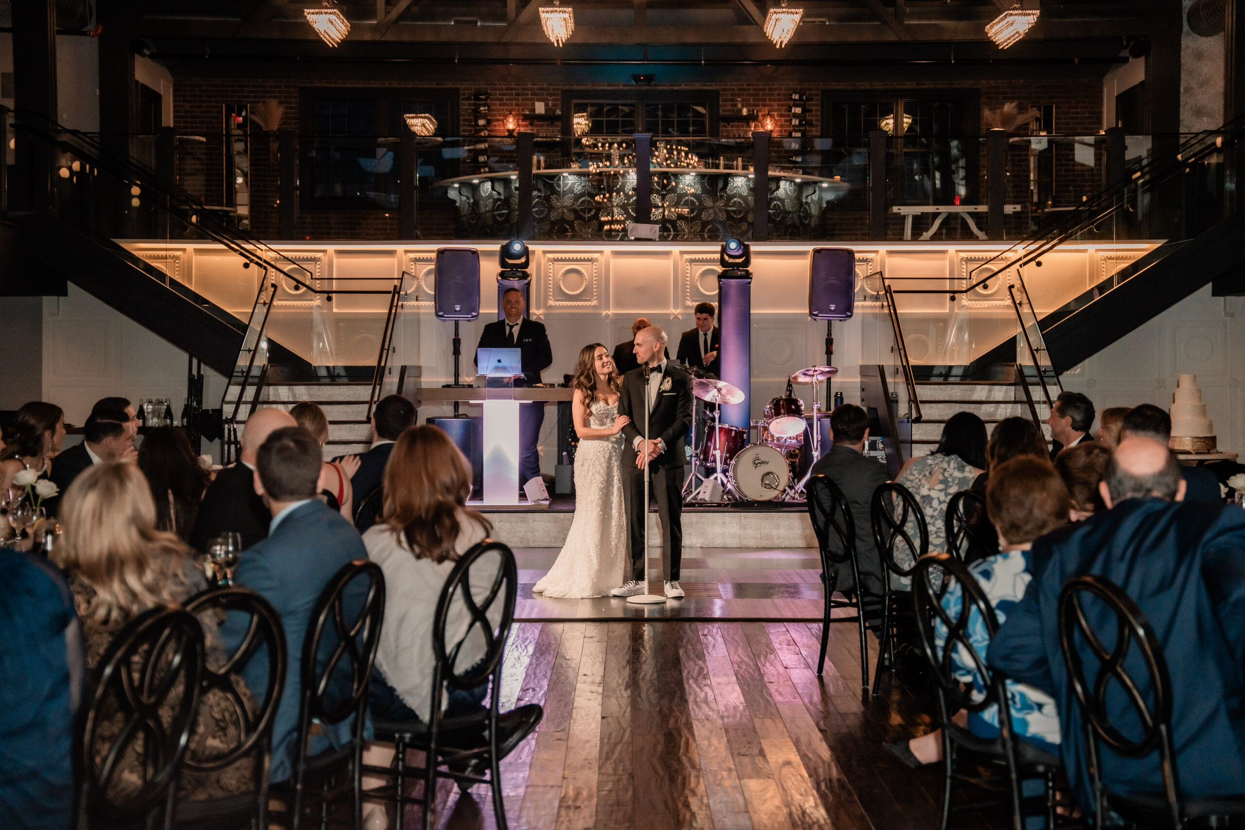 Park Loft wedding reception in Oceanport, NJ, with the bride and groom giving a thank-you speech in front of the ballroom dance floor.