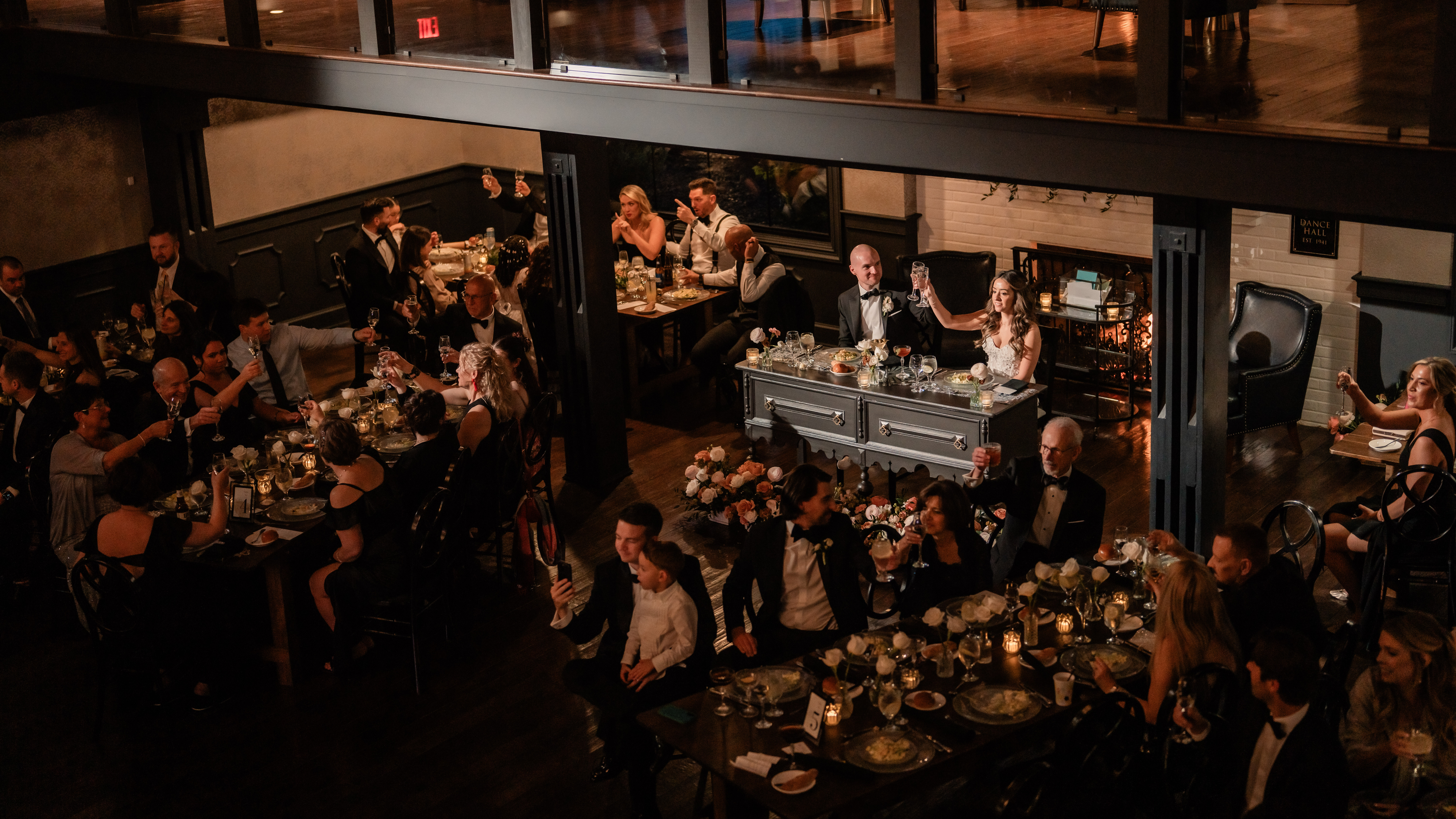 Overhead Park Loft wedding reception photography from the balcony, showing the sweetheart table, guests and elegant ballroom setup in Oceanport, NJ.