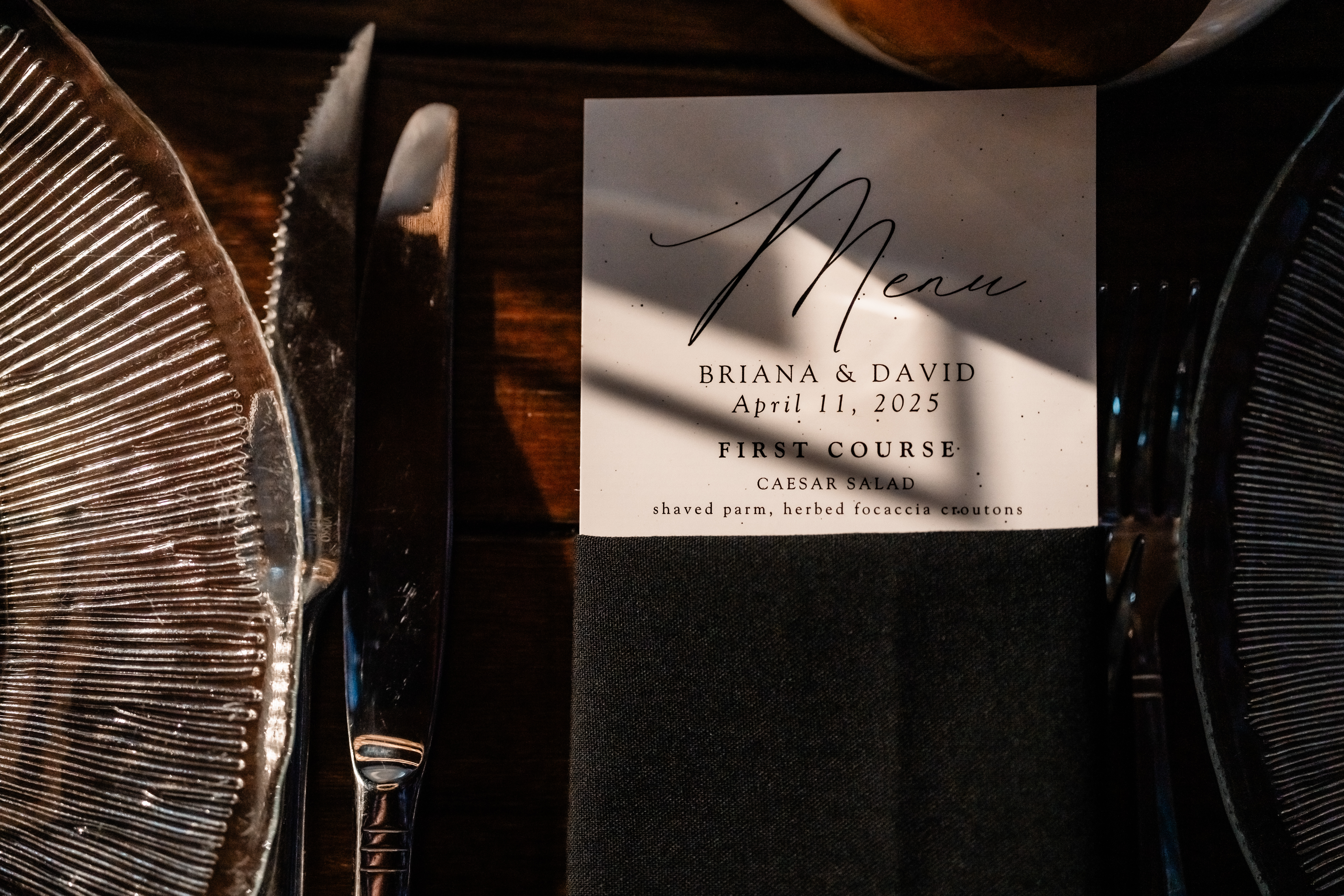 Park Loft wedding detail photography showing a personalized dinner menu and modern black table setting at the Oceanport, NJ reception.